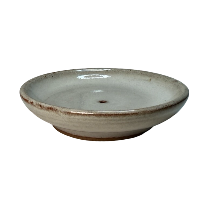 side view of a gray round incense holder