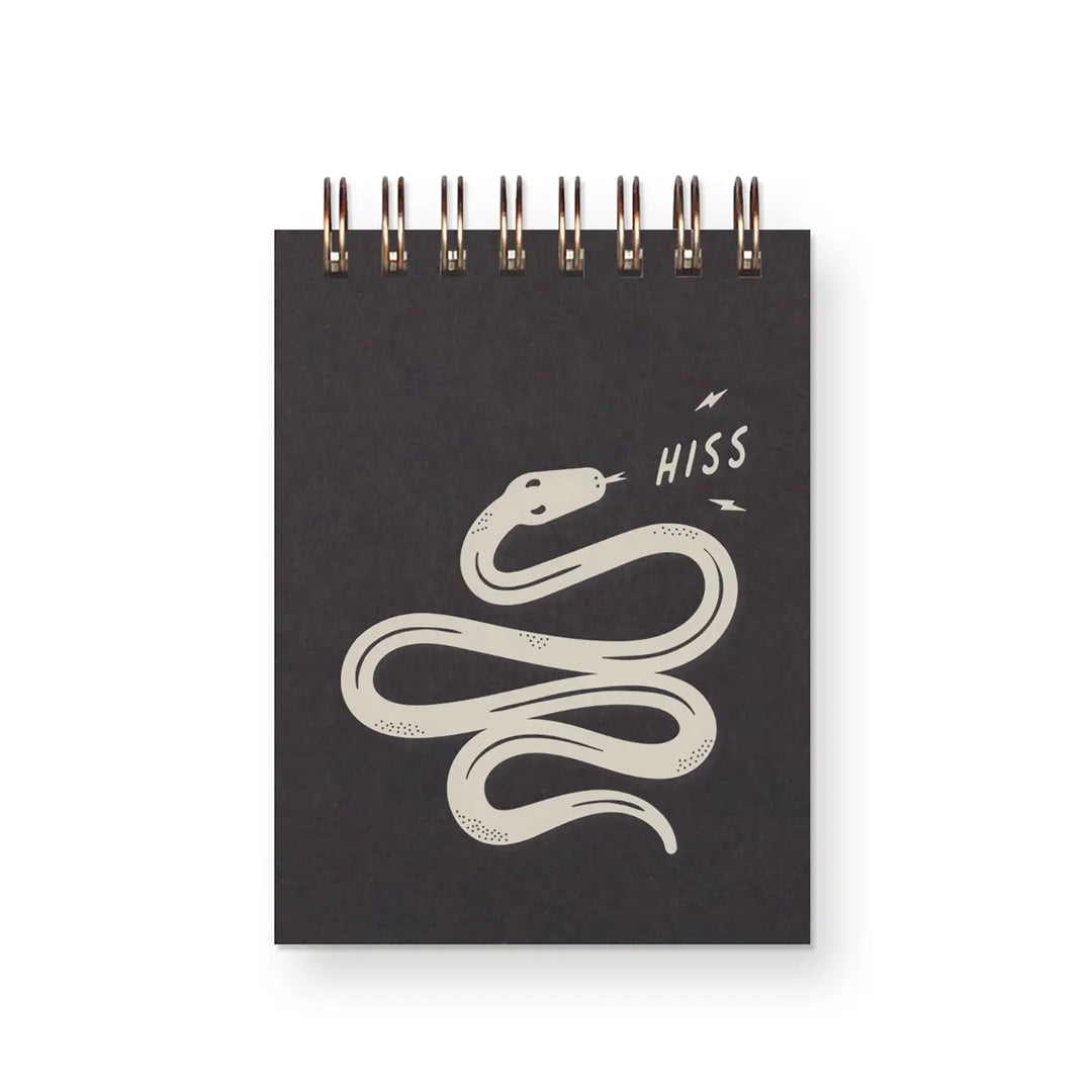 Small black spiral notebook with a cream-colored snake illustration and the word "HISS" in playful lettering.