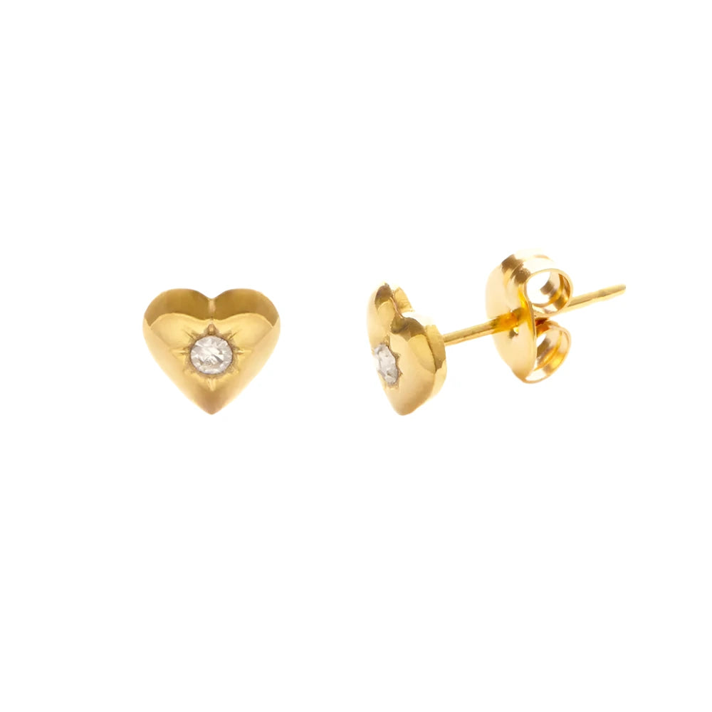 A pair of gold heart-shaped stud earrings featuring a small clear crystal in the center. One earring is shown from the front, while the other displays the post