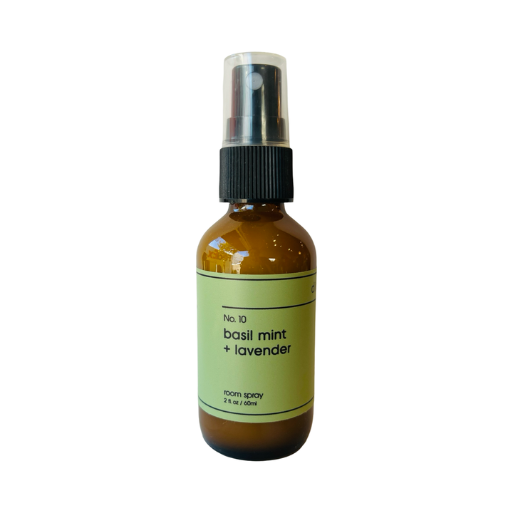2 oz brown spray bottle with a green branded label  of basil mint & lavender spray.