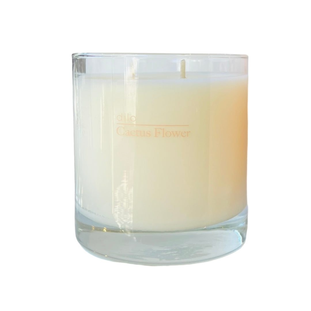 clear 8.5 oz cream colored candle with the phrase Cactus Flower in peach coloring