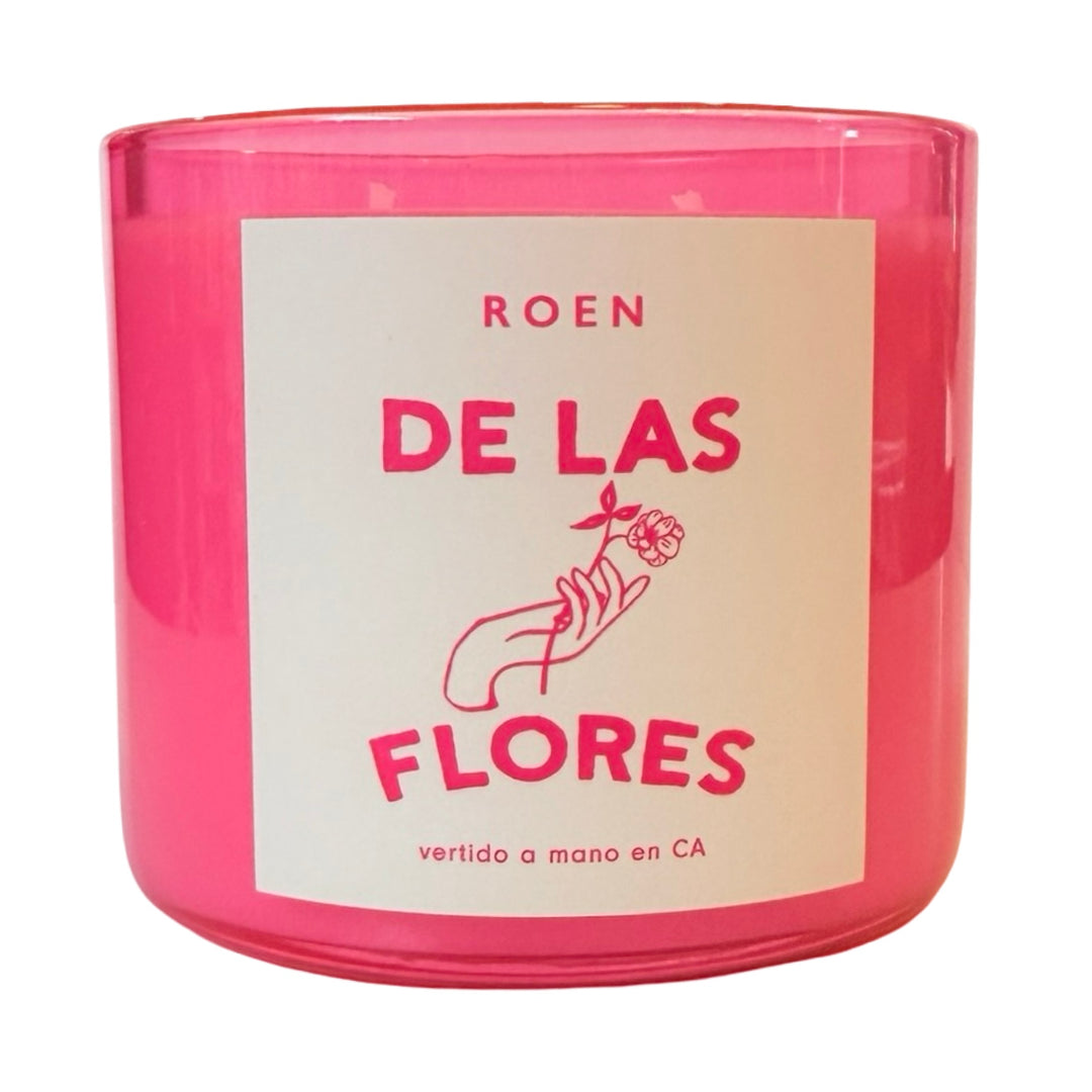 Photo of pink candle jar with branded label that reads "Roen - De Las Flores - Vertido a mano en CA"
