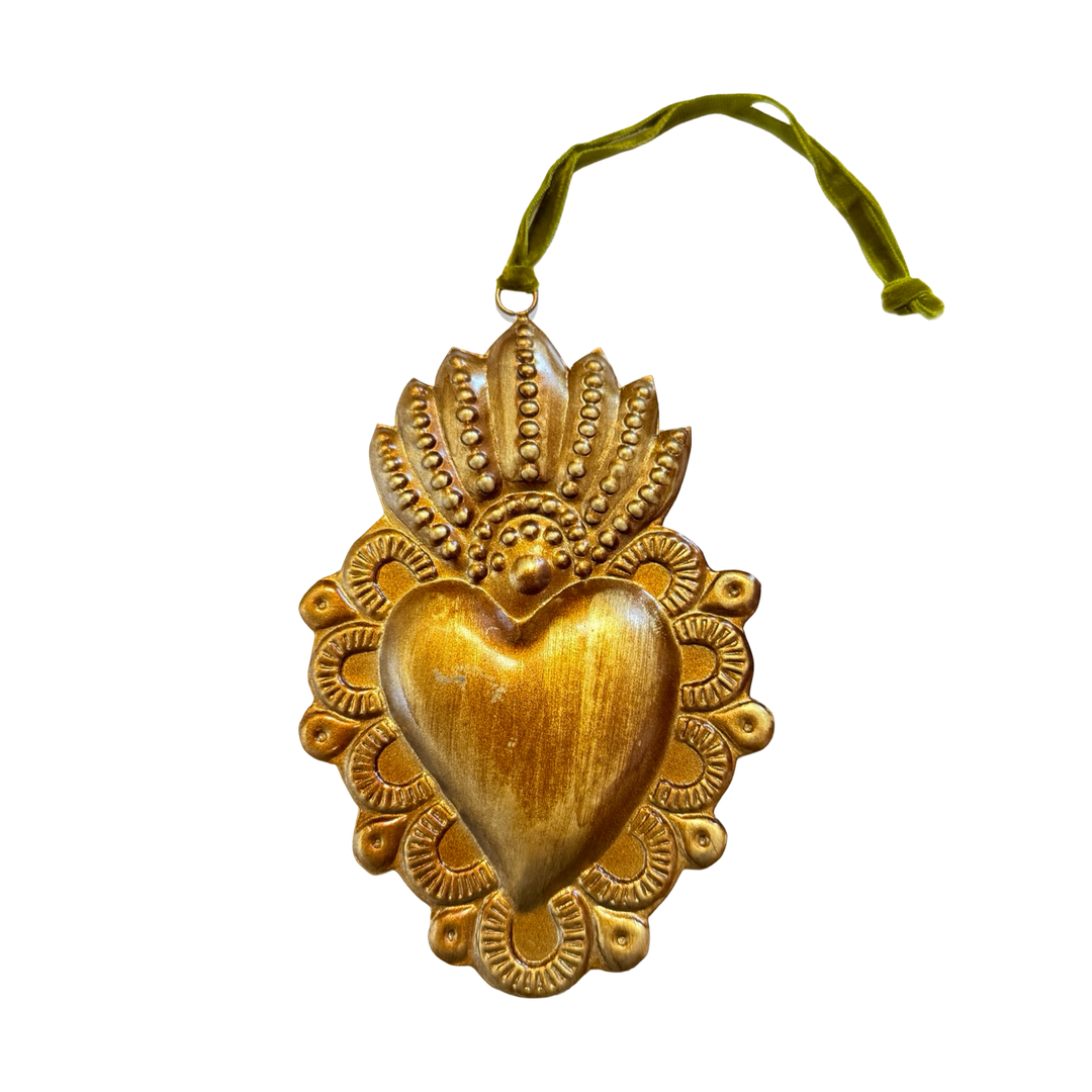 Gold ornament with embossed Sacred Heart design also featuring a green velvet loop for hanging