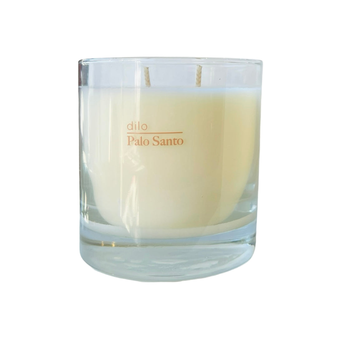 clear 8.5 oz cream colored candle with the phrase Palo Santo in tan coloring