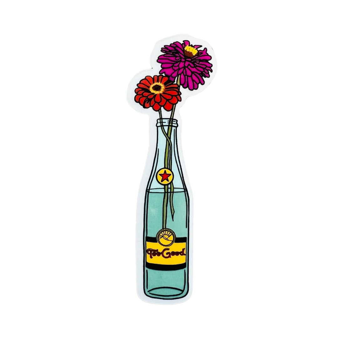 Topo chico bottle with two flowers sticking out of it; one pink and one red.