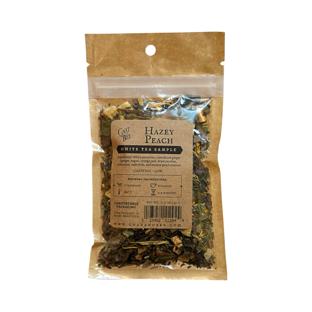 .5 oz kraft pouch of Hazey Peach White tea and a branded kraft label with a clear window that displays the dried herbs, fruits and flowers.