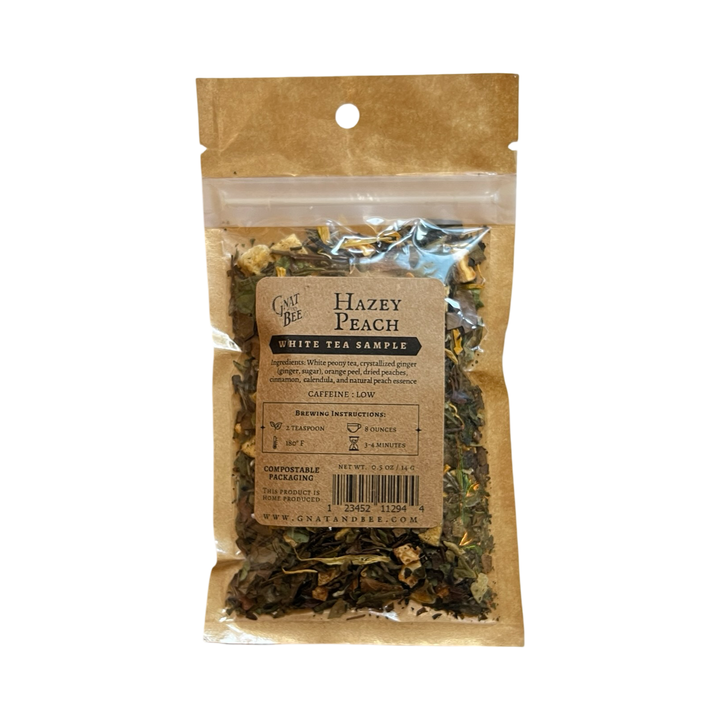 .5 oz kraft pouch of Hazey Peach White tea and a branded kraft label with a clear window that displays the dried herbs, fruits and flowers.