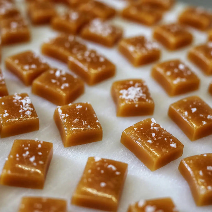 photo of square cut caramel candy pieces lightly dusted with salt flakes