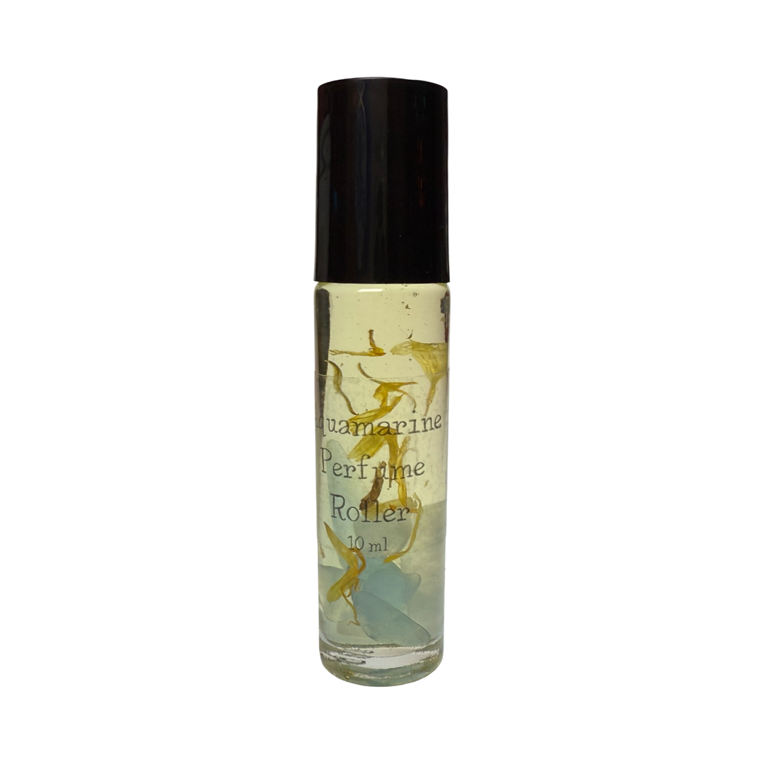 A Aquamarine Perfume Roller in a clear glass bottle with a black cap. The bottle contains small crystals and dried flower petals infused in liquid with the product name in white lettering.