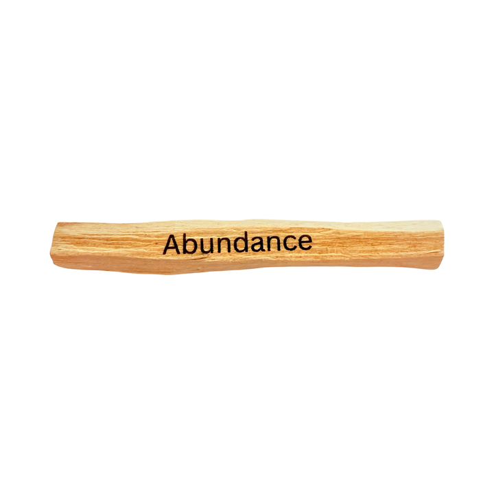 palo santo stick engraved with the word abundance