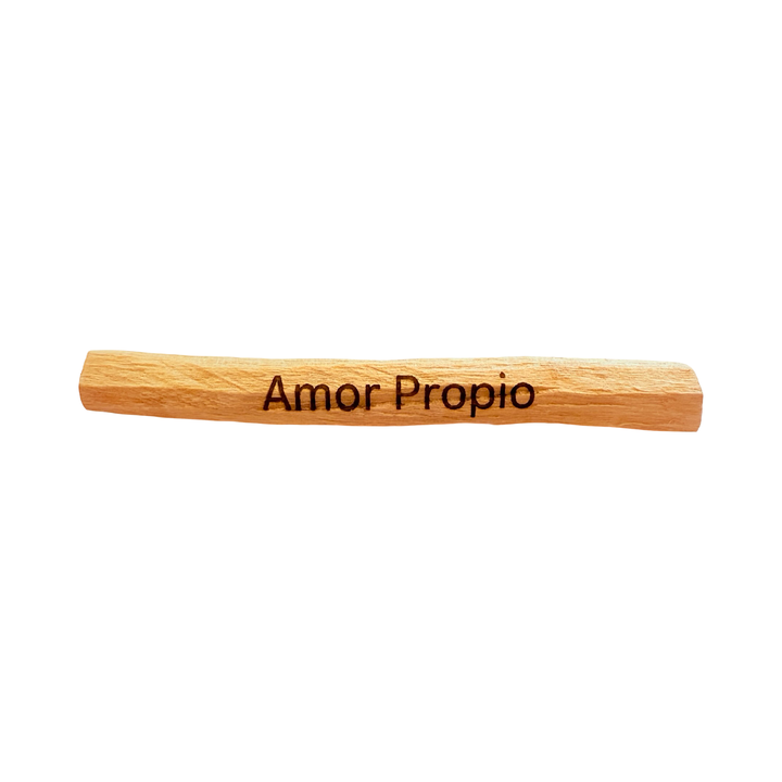 palo santo stick engraved with the word amor propio-proper love.