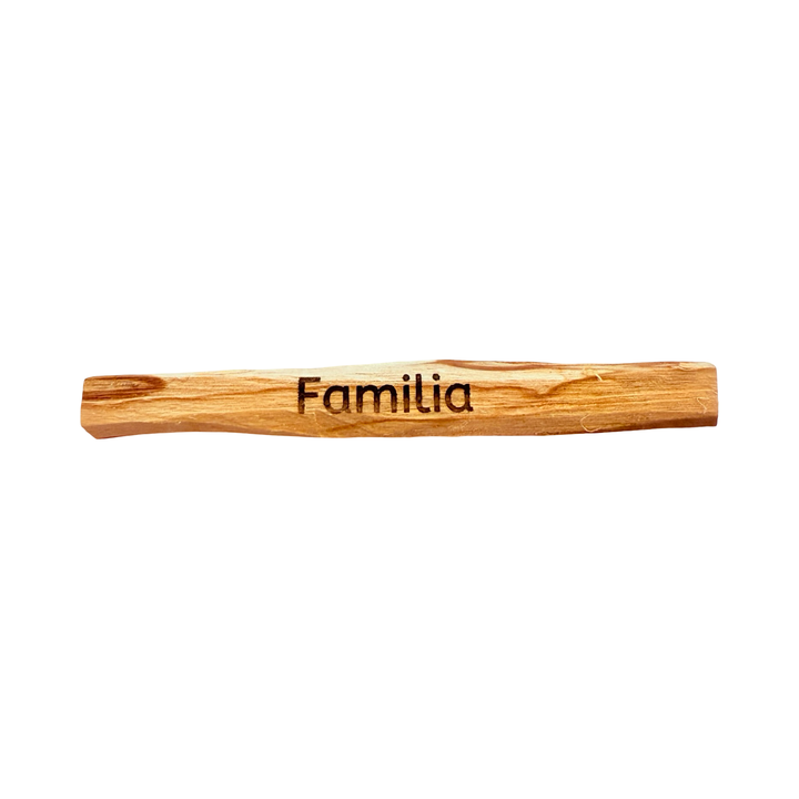 palo santo stick engraved with the word familia -family