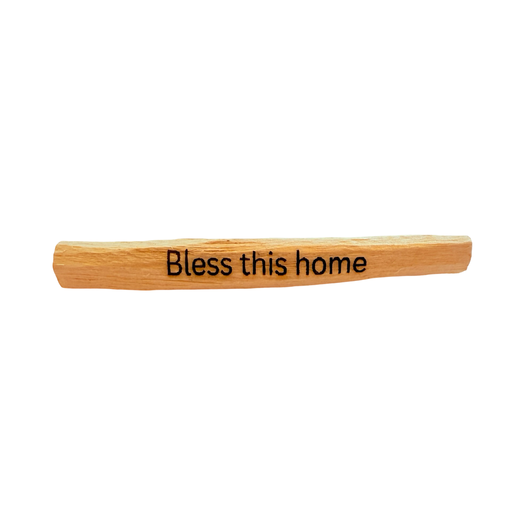 palo santo stick engraved with the phrase Bless this home.