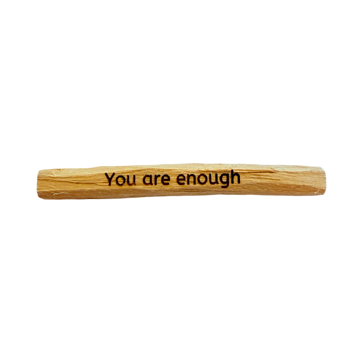 palo santo stick engraved with the phrase you are enough.