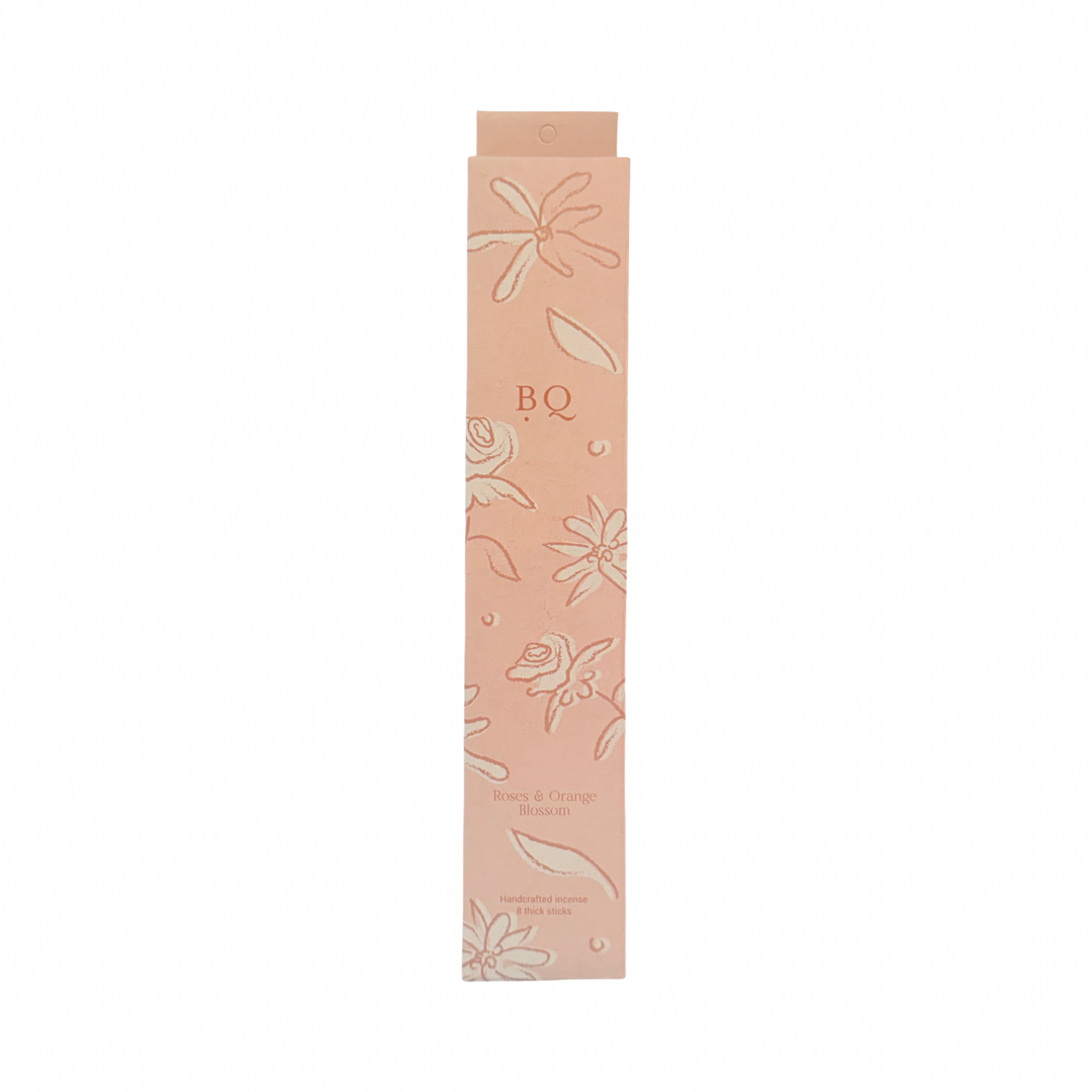 blush box of roses and orange blossom incense sticks with a floral design.