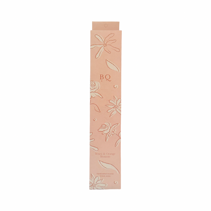 blush box of roses and orange blossom incense sticks with a floral design.