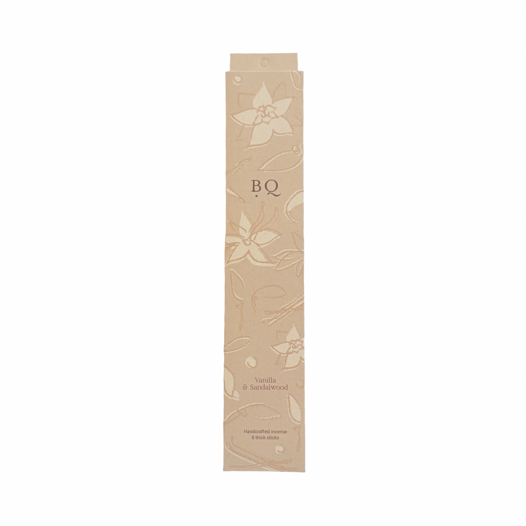 beige box of vanilla and sandal wood incense sticks with a floral design.