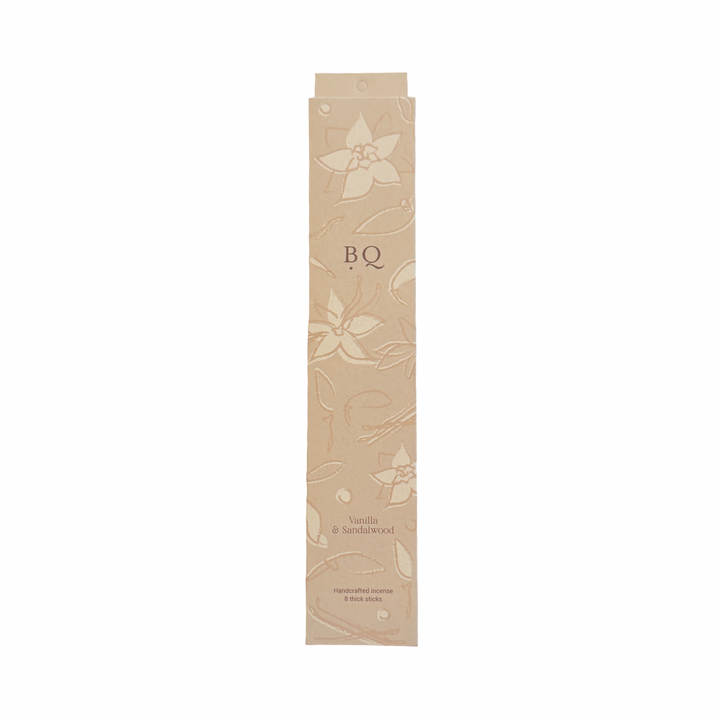 beige box of vanilla and sandal wood incense sticks with a floral design.