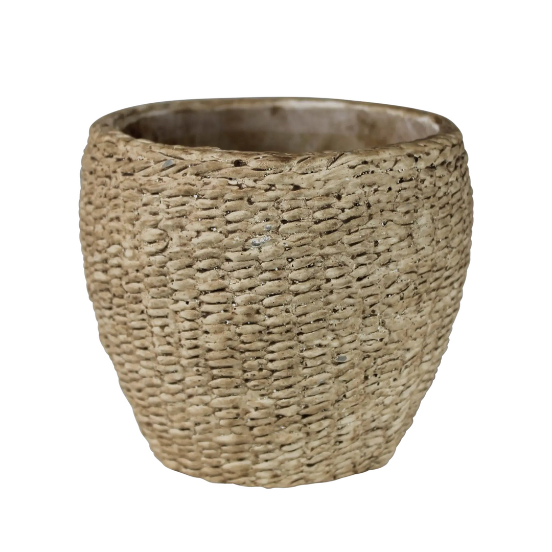 A textured cement cachepot with a woven basket-like design in earthy tones.