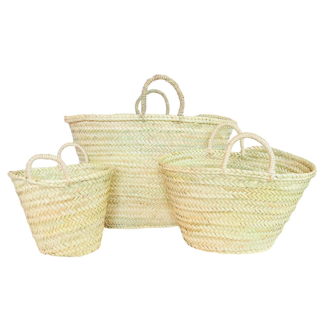 set of 3 handwoven straw market baskets made from natural palm leaves, featuring a wide, open-top design and sturdy braided handles.