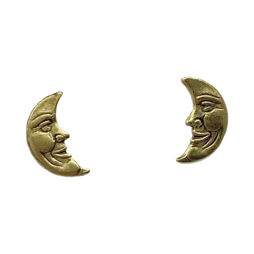 set of gold crescent moon stud earrings that feature a face