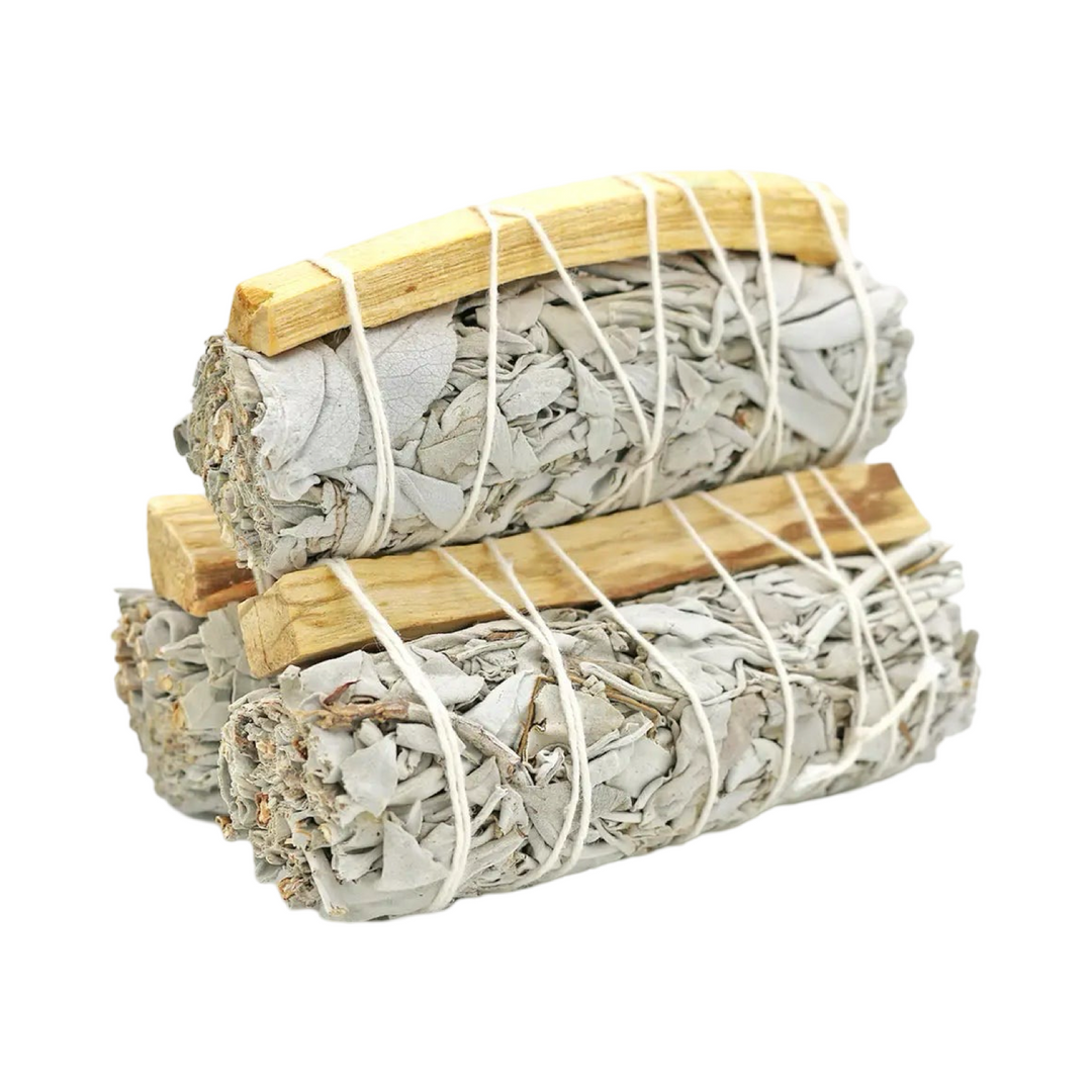 stack of 3 sage bundles with a palo santo stick.