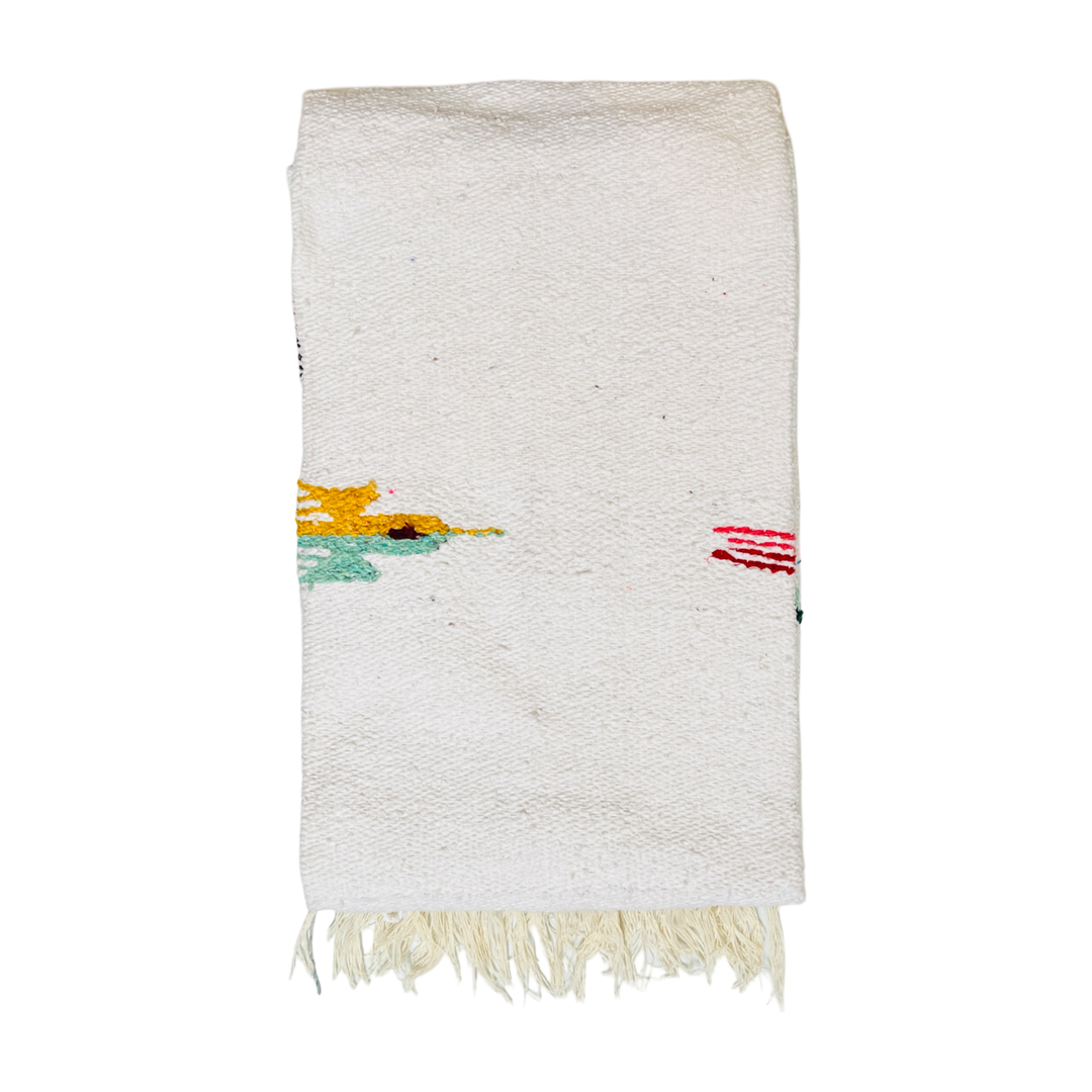 quarter folded white woven blanket with a bird design