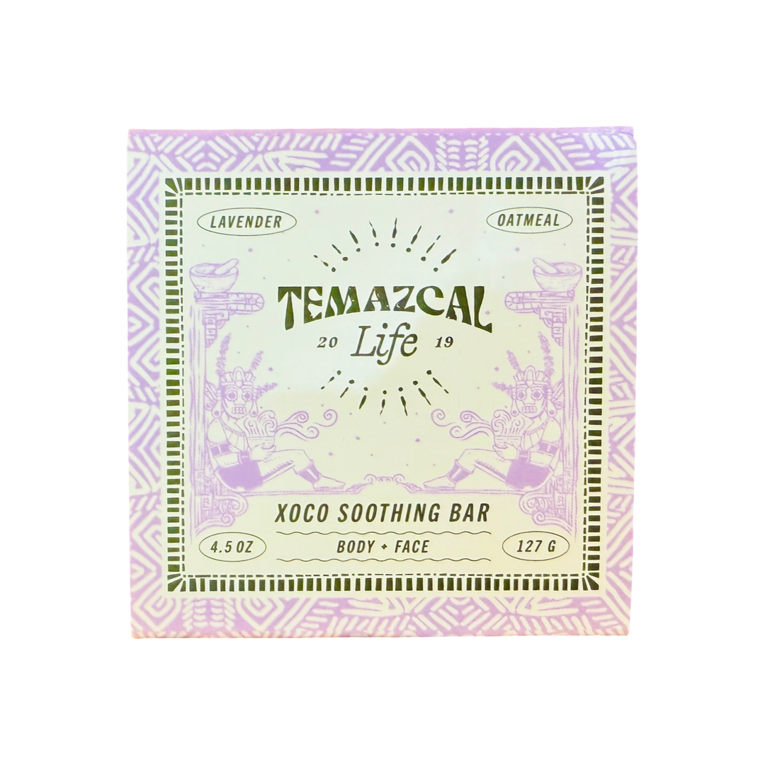 Close-up of the Temazcal Life Xoco Soothing Bar box featuring lavender and oatmeal, with intricate purple Aztec-inspired patterns and detailed illustrations surrounding the brand name.