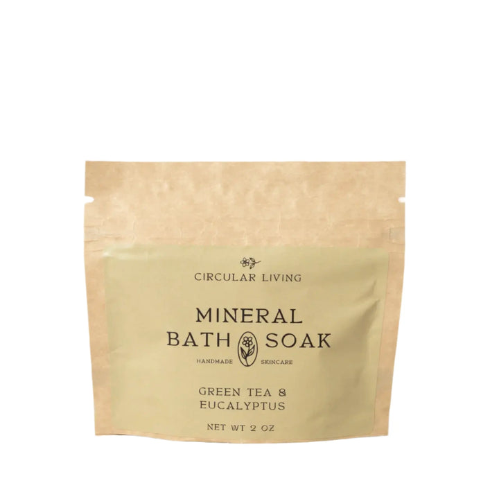 A kraft paper sachet labeled "Circular Living Mineral Bath Soak – Green Tea & Eucalyptus"
