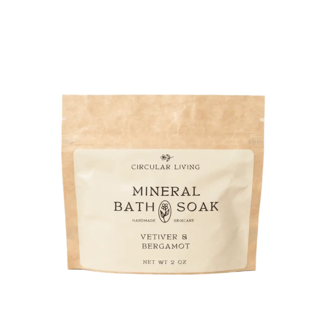 A kraft paper sachet labeled "Circular Living Mineral Bath Soak – Vetiver & Bergamot"