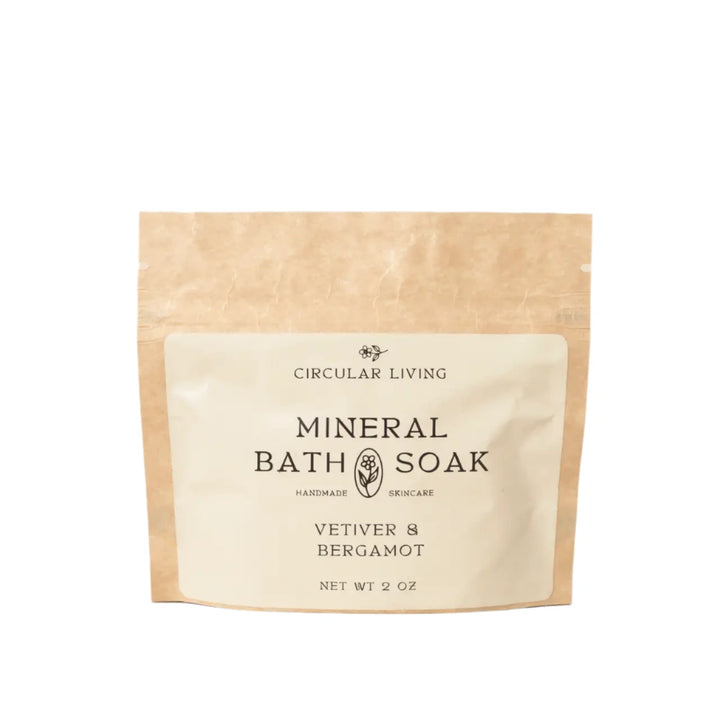 A kraft paper sachet labeled "Circular Living Mineral Bath Soak – Vetiver & Bergamot"
