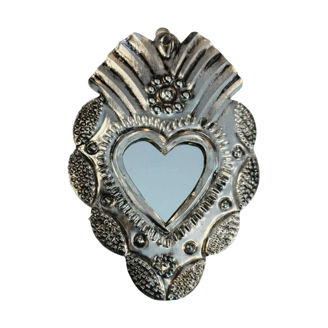 Tin heart shaped wall hanging with a mirror in the center.
