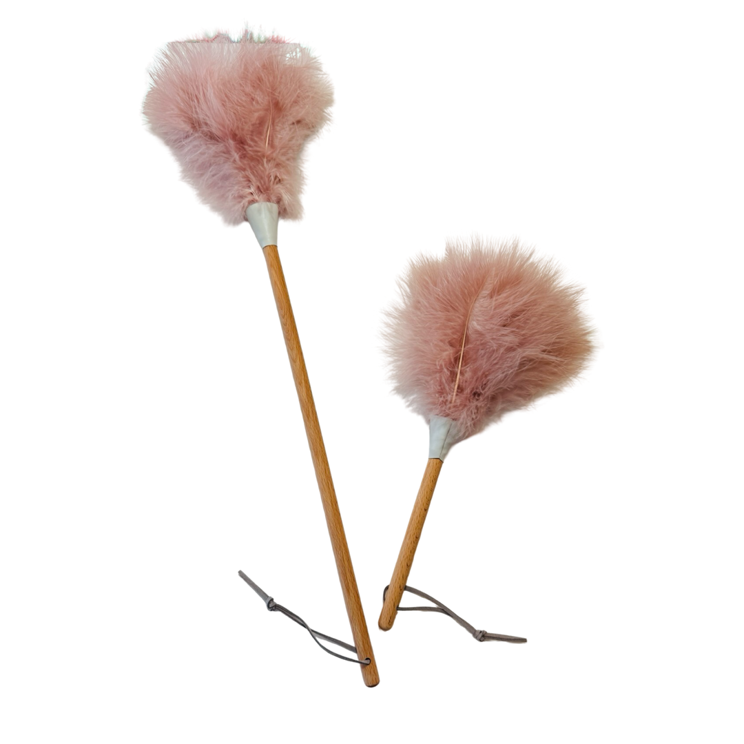 set of pink ostrich feather dusters, one larger than the other, with a wooden handle and hanging loop