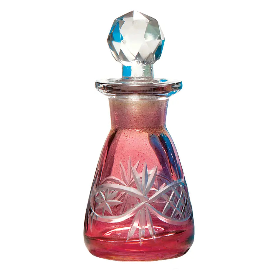 Red glass perfume bottle with etched floral and ribbon designs, topped with a faceted crystal stopper.