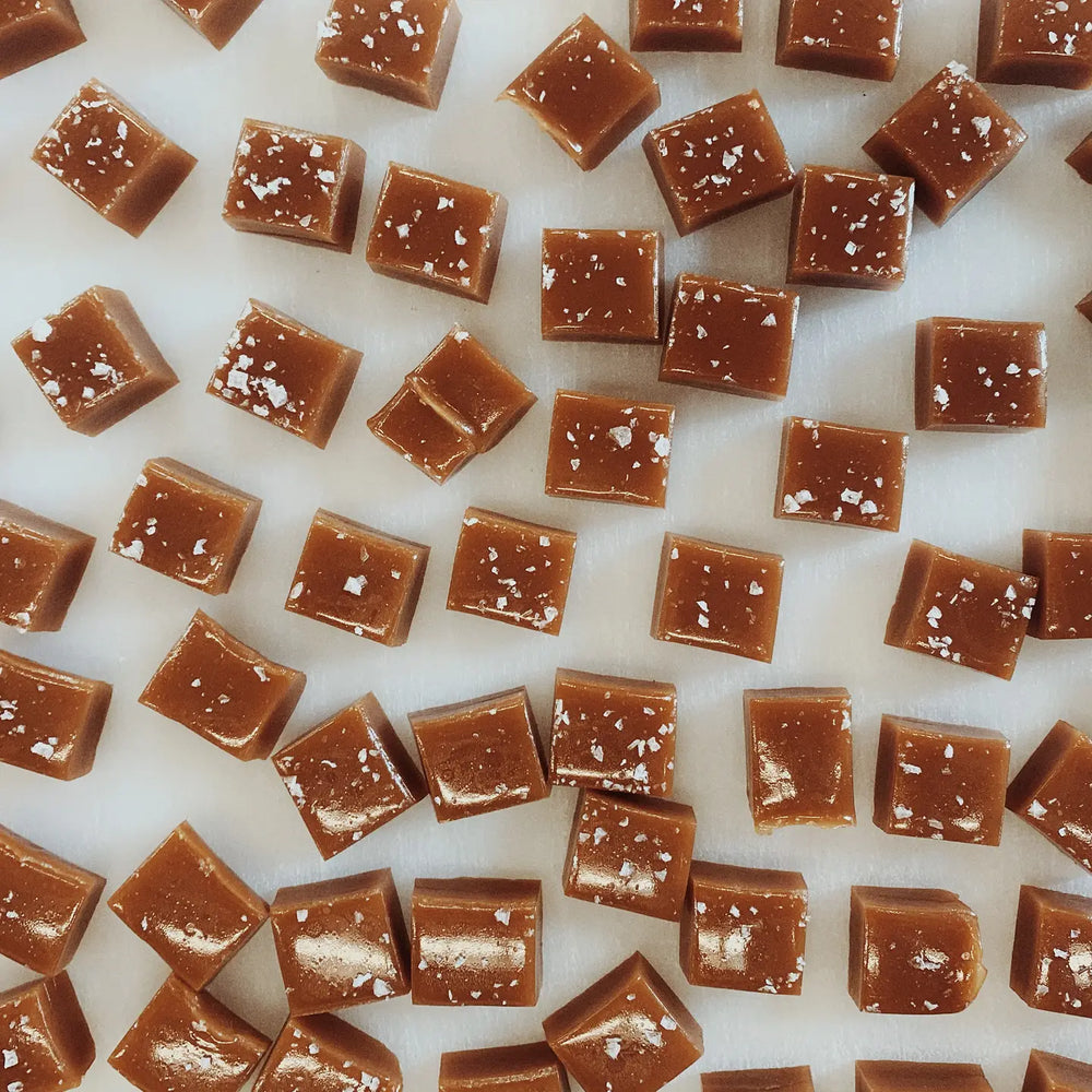photo of square cut caramel candy pieces lightly dusted with salt flakes