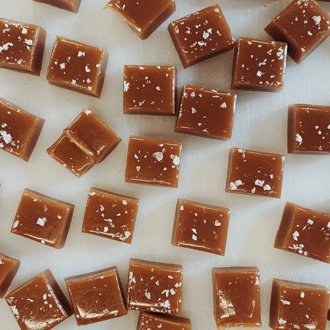 photo of square cut caramel candy pieces lightly dusted with salt flakes
