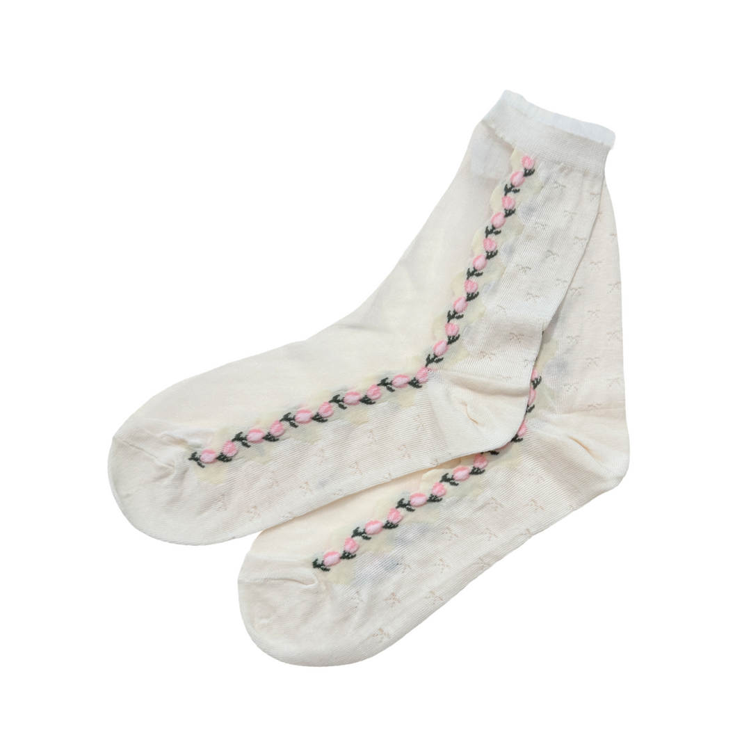 Photo of cream colored socks, top of sock is shear & sides are decorated with pink tulips