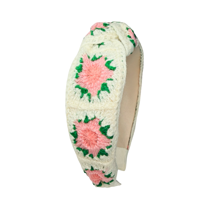 Cream crochet headband with pink and coral floral patterns and a knotted top design.