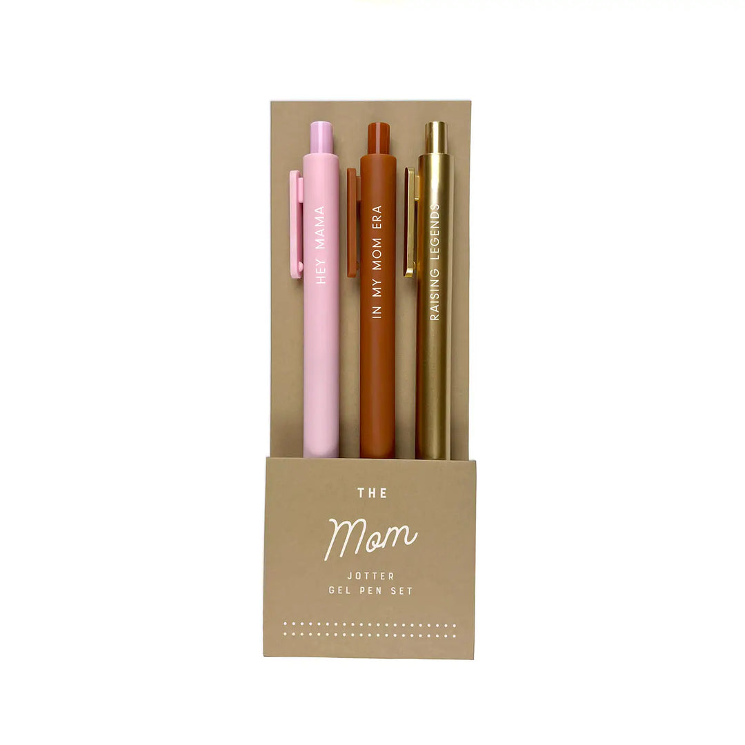 Set of three gel pens labeled “Hey Mama,” “In My Mom Era,” and “Raising Legends” in a tan package titled “The Mom Jotter Gel Pen Set.”