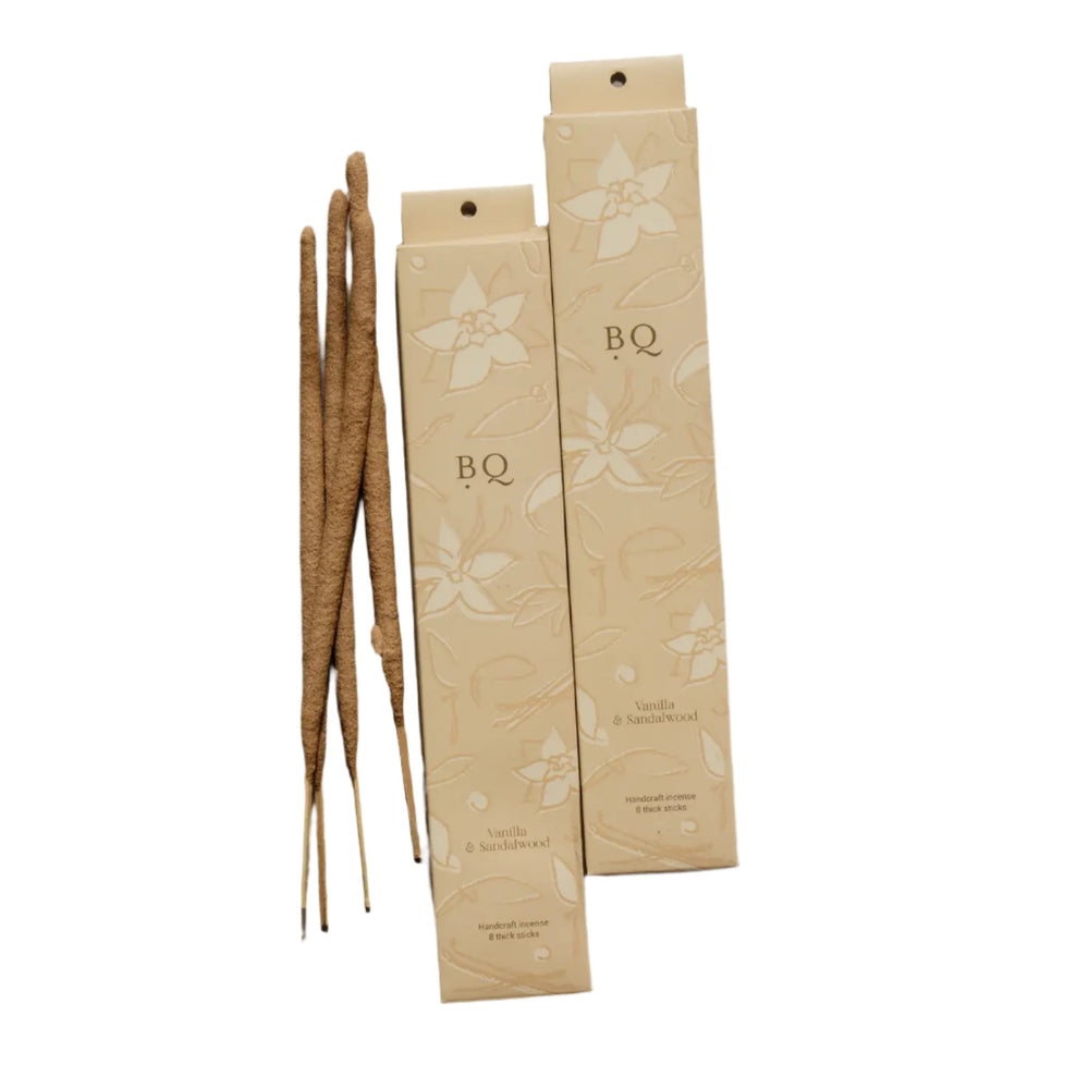 2 beige boxes of vanilla and sandal wood incense sticks with a floral design featuring 4 sticks of incense.