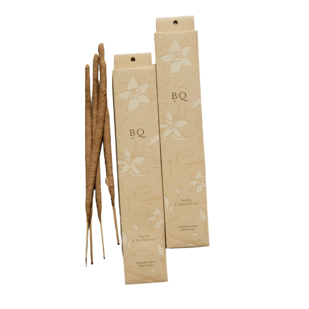 2 beige boxes of vanilla and sandal wood incense sticks with a floral design featuring 4 sticks of incense.