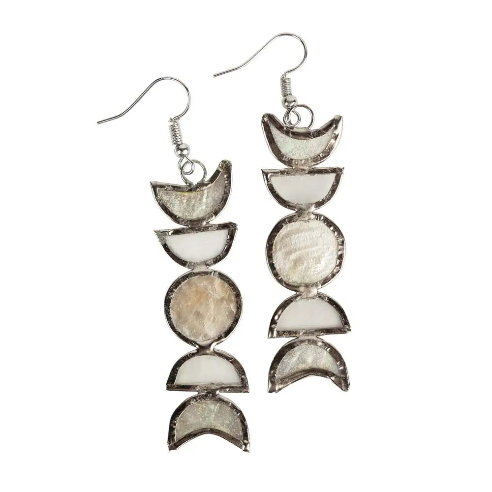 A pair of dangle earrings featuring moon phase shapes made from capiz shells in white and iridescent hues, set in a silver-toned metal frame with fishhook ear wires.