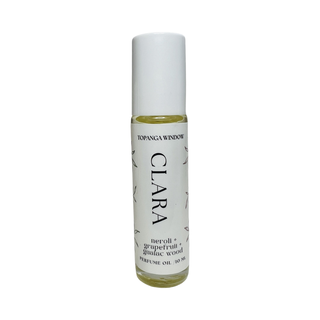 10 mil glass tube of perfume oil with a white branded label. Brand: Topanga Window