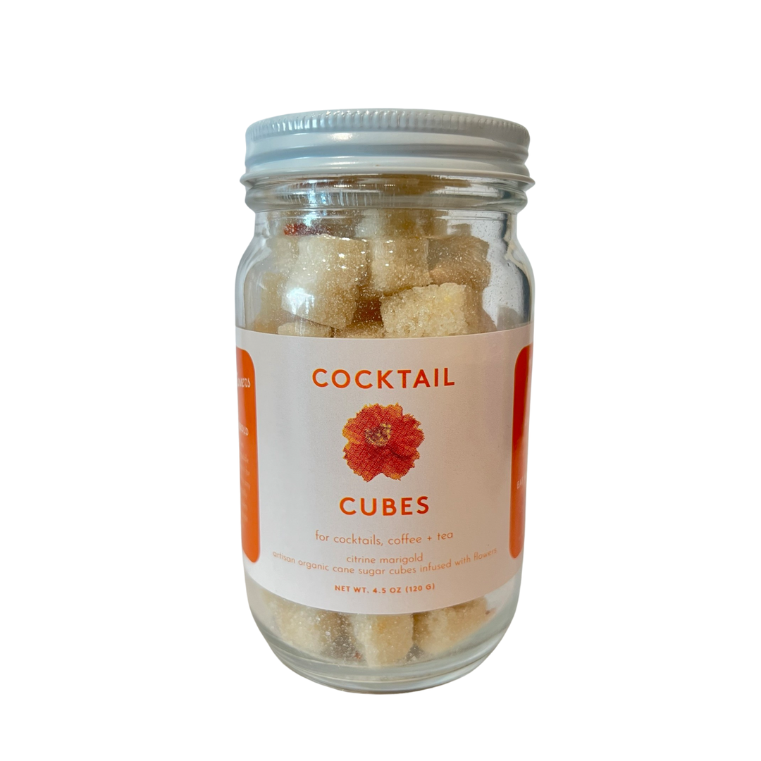 4.5 oz clear jar with sugar cubes and a white brand label with an image of a marigold.