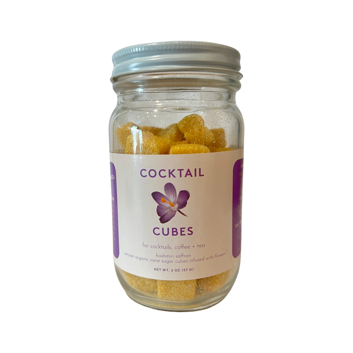2 oz clear jar of sugar cubes with a white and purple brand label with an image of a purple saffron flower.