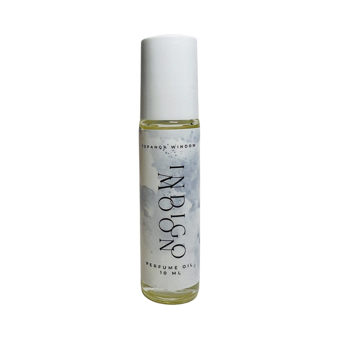 10 mil glass tube of perfume oil with a white branded label. Brand: Topanga Window