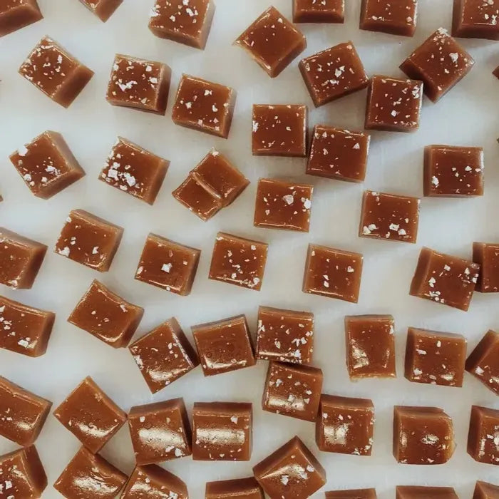 photo of square cut caramel candy pieces lightly dusted with salt flakes