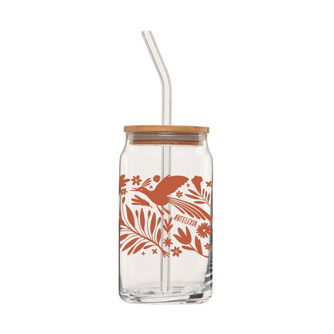 Back view of clear can glass featuring a wraparound print of a terra cotta colored otomi design. This glass also comes with a bamboo lid & a clear glass drinking straw.