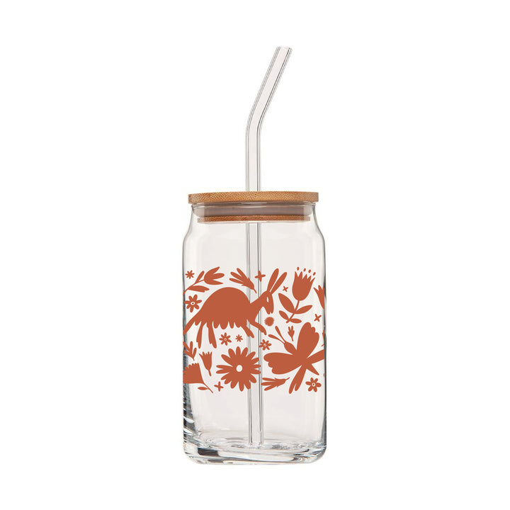 Front view of clear can glass featuring a wraparound print of a terra cotta colored otomi design. This glass also comes with a bamboo lid & a clear glass drinking straw.