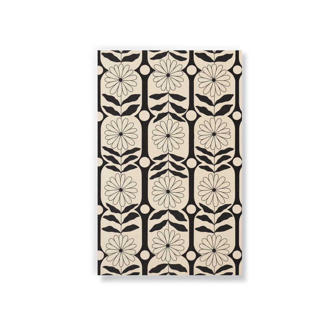 beige notebook with a black flower pattered design